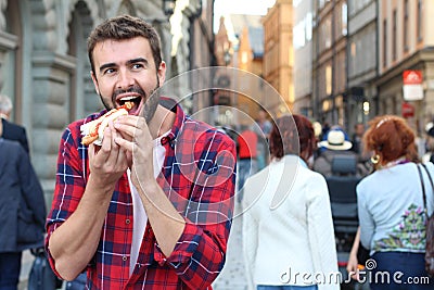 Hungry male devouring a hot dog Stock Photo