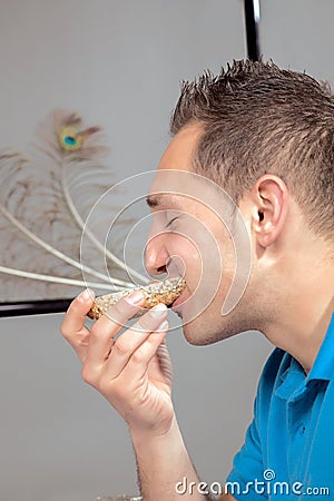 Hungry man eating a wholewheat roll Stock Photo