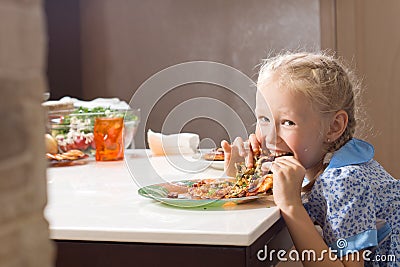 Hungry pretty little girl devouring homemade pizza Stock Photo