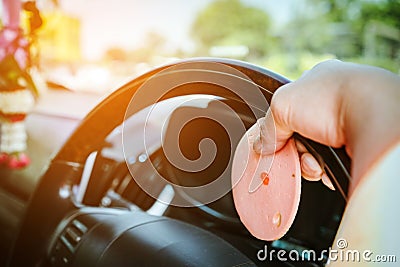 Hungry woman driving her car while eating bologna with ice coffee in the traffic. Stock Photo