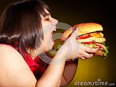 Hungry woman holding hamburger. Stock Photo