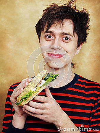 The hungry young man eats a hamburger Stock Photo
