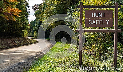 A Hunt Safely sign on the side of the road in the woods in Deerfield Township, Pennsylvania, USA Stock Photo