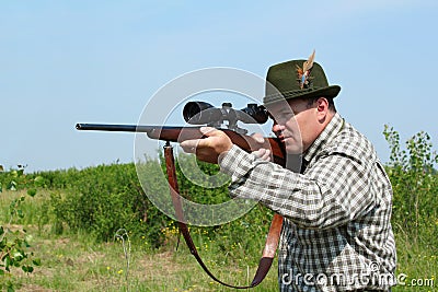 Hunter aiming with rifle Stock Photo