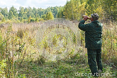 Hunter is calling a moose during the rut hunting Stock Photo