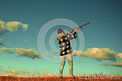 Hunter in the fall hunting season. Hunter with shotgun gun on hunt. Skeet shooting. Stock Photo