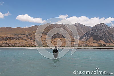 Hunter fording river Stock Photo