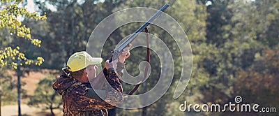 Hunter with a hat and a gun in search of prey in the steppe, Aims for prey. Stock Photo