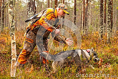 Hunter and his elkhound outdoor - hunting season Stock Photo