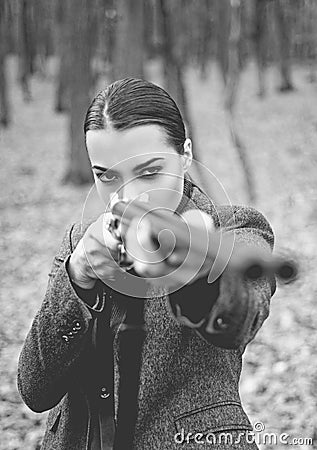 A hunter with a hunting gun and hunting form to hunt. Hunter woman. Hunter with a backpack and a hunting gun. Black and Stock Photo