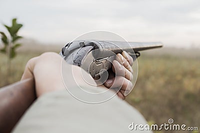 Hunter With Old Hunting Riffle Waiting for Pray in the Woods Stock Photo