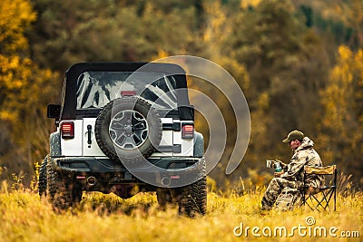 A Hunter Relaxing During Hunting Trip Stock Photo