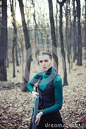 Hunter woman. Hunter with a backpack and a hunting gun. Hunting period, autumn season. Female with a gun. A hunter with Stock Photo