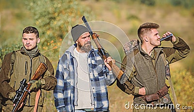 Hunters with rifles in nature environment. Illegal hunting. Hunters brutal poachers. Poacher partner in crime. Poaching Stock Photo