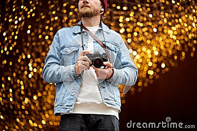 Hunting for best shots. Portrait of urban photographer with vintage retro camera Stock Photo