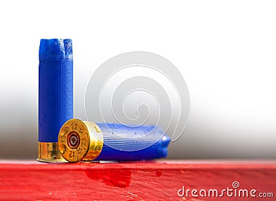 Hunting cartridge blue used lies on the red table Stock Photo