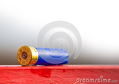 Hunting cartridge blue used lies on the red table Stock Photo