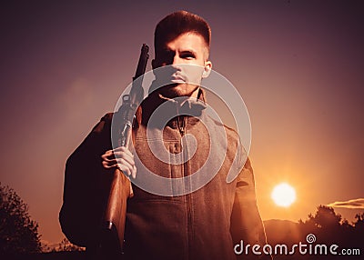 Hunting Equipment for sale. Rifle Hunter Silhouetted in Beautiful Sunset. Hunting without borders. Portrait of Hunter. Stock Photo