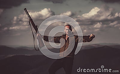 Hunting Gear - Hunting Supplies and Equipment. A hunter with a hunting gun hunt in summer forest. Collimating sight Stock Photo