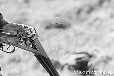 Hunting season. Hunter equips the retro double-barreled shotgun with cartridges, close up Stock Photo