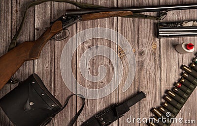 The frame is made of hunting weapons, a bandoleer with cartridges, binoculars in a case, a knife in a sheath, equipment for cleani Stock Photo