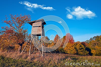 Hunting tower in wild forest. Wooden Hunter Hide High watch post tower. Hunter`s observation point in forest in Europe Stock Photo