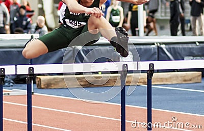 Hurdler running race indoors Stock Photo