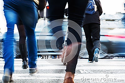 Hurried people crossing a city street Stock Photo