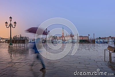 a man in a hurry with umbrella Stock Photo