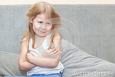 Hurt the feelings little girl sitting on the couch Stock Photo