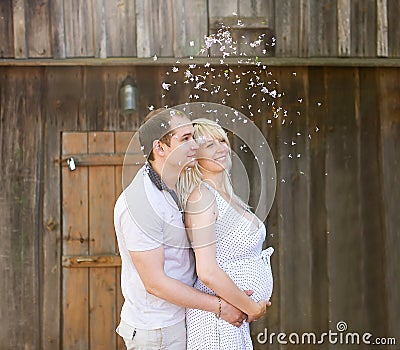 The husband embraces the pregnant wife. Stock Photo