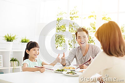 Husband gives his wife thumbs up for the delicious dinner Stock Photo