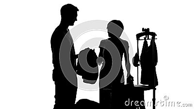 Husband giving wife clothes for ironing, women home chores, housekeeping routine Stock Photo