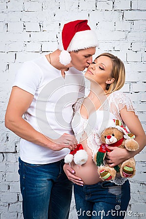 Husband kisses his wife. Concept New Year and happy pregnancy. Stock Photo