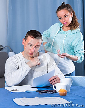 Husband and pregnant wife arguing at home Stock Photo