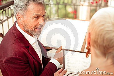 Husband speaking with wife while deciding what to order Stock Photo