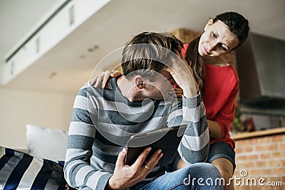 Husband stressed being comforted by wife Stock Photo