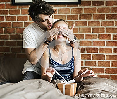 Husband surprises his wife with a gift Stock Photo
