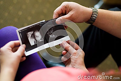 The husband and th looking at sonogram while lying Stock Photo