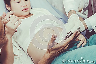 The husband watched his wife on the bed in the hospital ward. Stock Photo