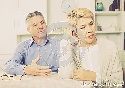 Husband and wife arguing with each other and try to resolve family conflict at table Stock Photo