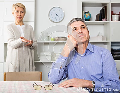 Husband and wife arguing with each other and try to resolve family conflict at table Stock Photo