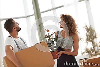 Husband and wife bring boxes with things to a new apartment Stock Photo