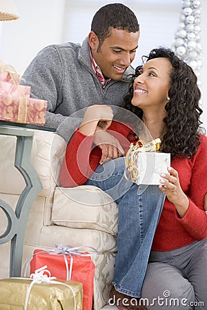 Husband And Wife Exchanging Christmas Gifts Stock Photo