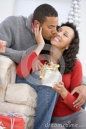 Husband And Wife Exchanging Christmas Gifts Stock Photo