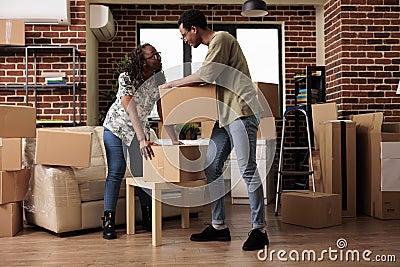 Husband and wife moving in new house bought on loan Stock Photo