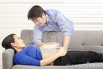 Husband and wife in pregnancy. Portrait of pregnant woman and husband smile.Father is pregnant mother`s stomach. Young future Stock Photo