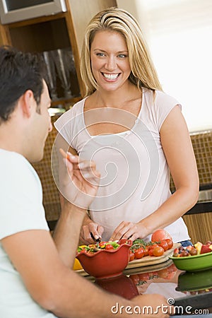 Husband And Wife Preparing Dinner Stock Photo