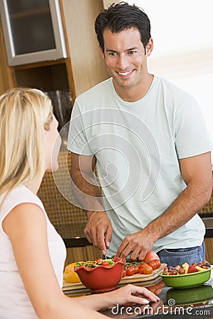 Husband And Wife Preparing Dinner Stock Photo