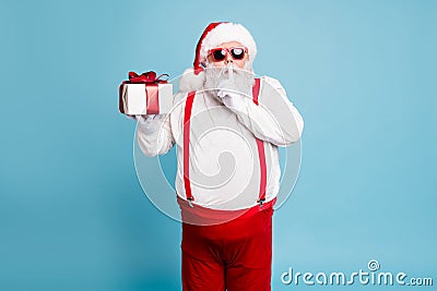 Hush its secret. Portrait of focused funny funky fat santa claus with big abdomen belly prepare gift for eve noel hold Stock Photo